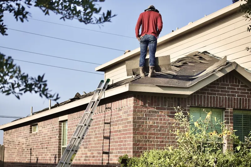 Professional roofer working on a residential roof in Westbridge